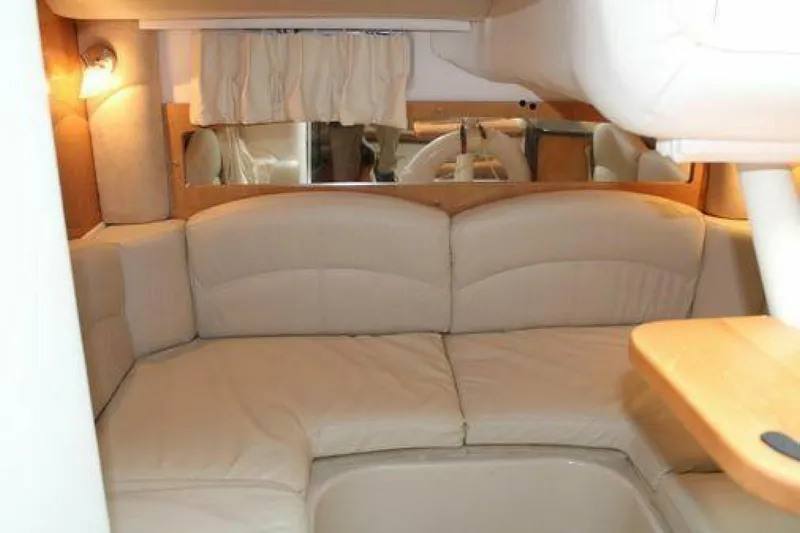  Yacht Photos Pics 2011 Four Winns V335 interior with beige seating and wooden accents.