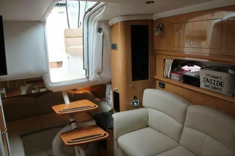  Yacht Photos Pics Interior of 2011 Four Winns V335 yacht with beige seating and wooden accents.