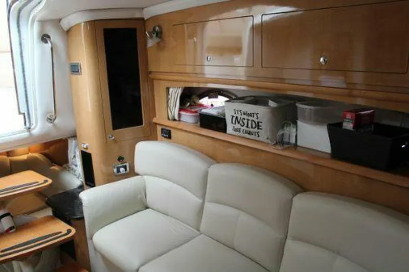  Yacht Photos Pics Interior of 2011 Four Winns V335 yacht with beige seating and wooden cabinetry.