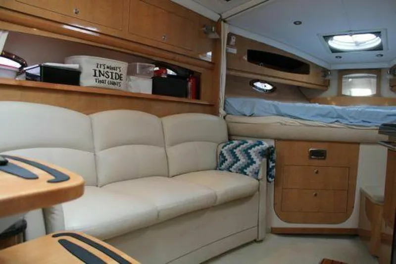  Yacht Photos Pics Interior of 2011 Four Winns V335 boat with cozy seating and wooden cabinetry.