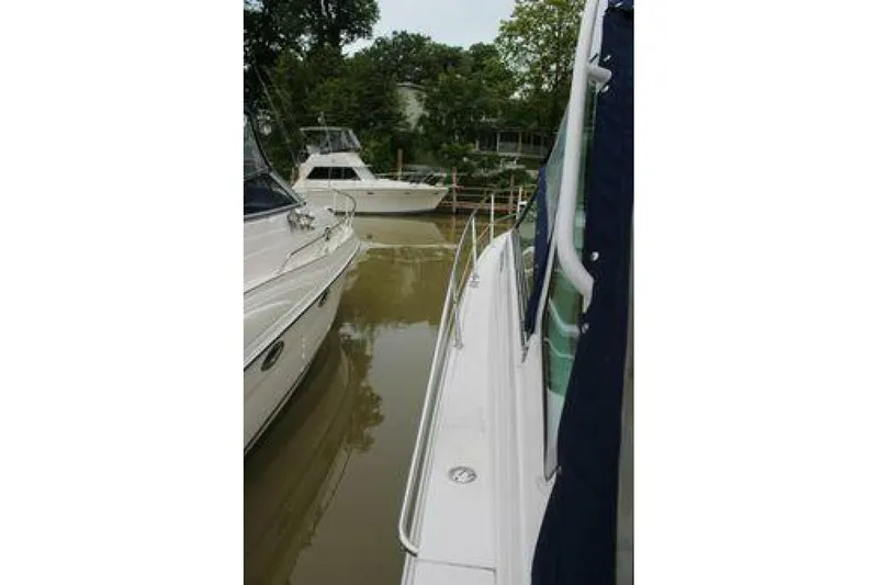  Yacht Photos Pics 2011 Four Winns V335 boat docked beside another vessel in a marina.