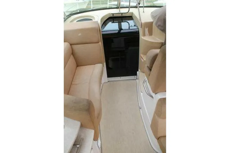  Yacht Photos Pics Interior of 2011 Four Winns V335 boat with beige seating and carpeted floor.