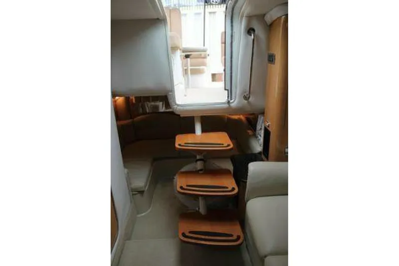  Yacht Photos Pics Interior of 2011 Four Winns V335 yacht with wooden steps and cozy seating area.