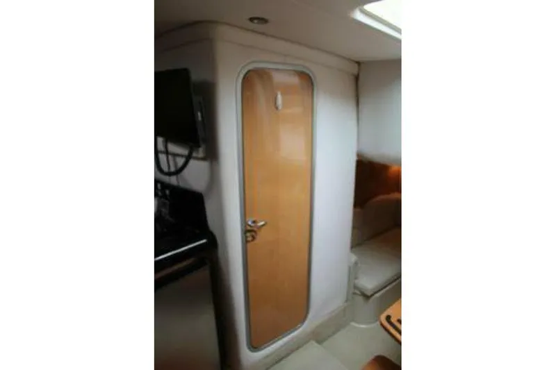 Yacht Photos Pics Interior cabin of 2011 Four Winns V335 boat with wooden door and seating area.