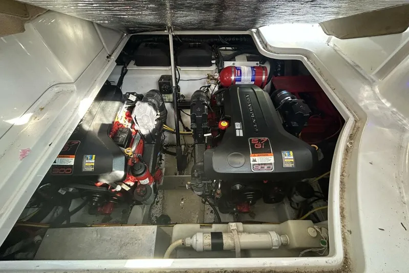  Yacht Photos Pics Engine compartment of a 2011 Four Winns V335 boat, featuring dual engines and a fire extinguisher.