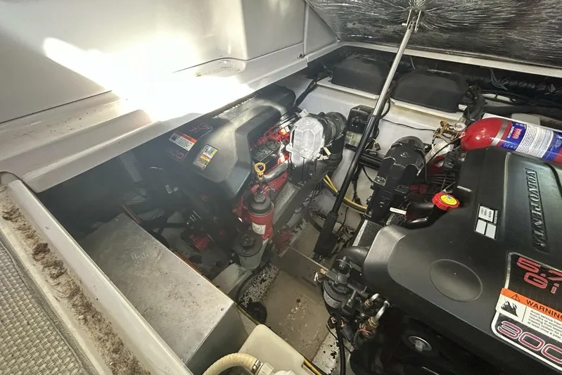  Yacht Photos Pics Engine compartment of a 2011 Four Winns V335 boat, featuring dual engines and fire extinguisher.
