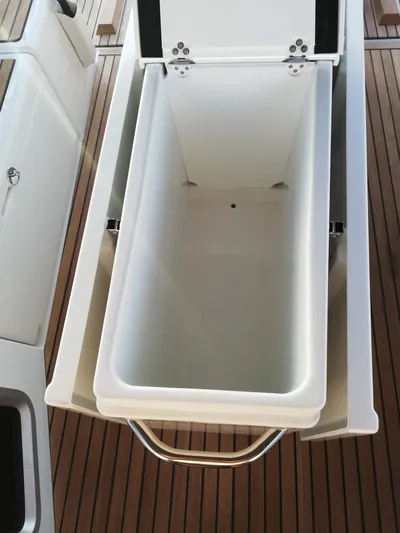  Yacht Photos Pics Storage compartment on 2020 Jeanneau Sun Odyssey 410 yacht, featuring sleek design and wooden deck.