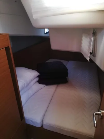  Yacht Photos Pics Cozy cabin interior of 2020 Jeanneau Sun Odyssey 410 sailboat with neatly arranged bedding.