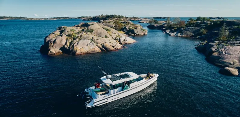  Yacht Photos Pics 2025 Axopar 37XC CROSS CABIN BRABUS Trim navigating scenic rocky waters.