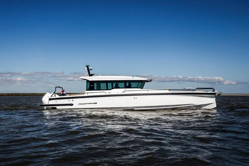  Yacht Photos Pics 2025 Axopar 37XC CROSS CABIN BRABUS Trim cruising on open water under clear skies.