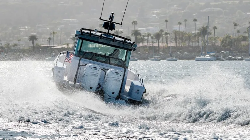  Yacht Photos Pics 2025 Axopar 37XC CROSS CABIN BRABUS Trim navigating through waves, showcasing powerful dual engines.