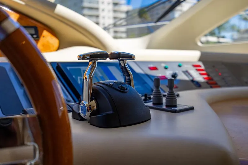 All In Yacht Photos Pics Control panel of 2010 Azimut 62 Evolution Fly yacht, featuring throttle levers and navigation instruments.