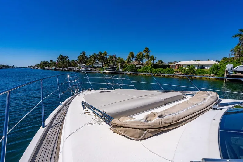 All In Yacht Photos Pics Luxurious 2010 Azimut 62 Evolution Fly yacht cruising on a sunny, tropical waterway.