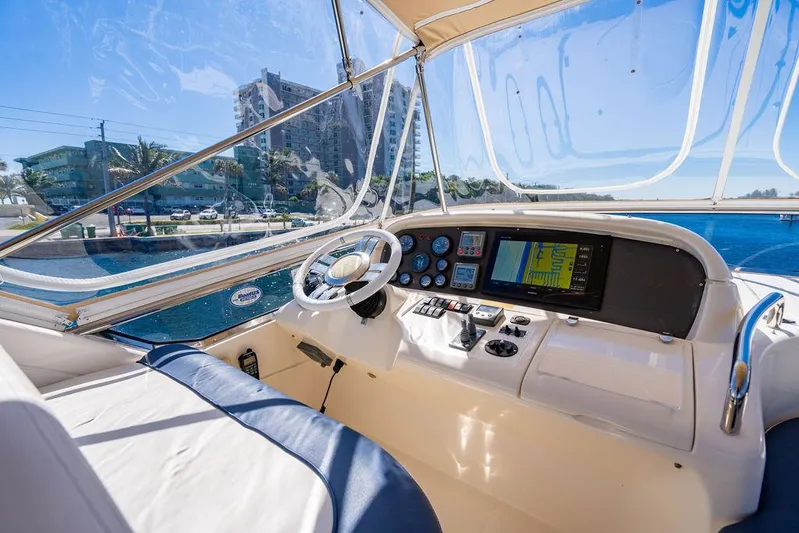 All In Yacht Photos Pics 2010 Azimut 62 Evolution Flybridge yacht helm with navigation controls and waterfront view.