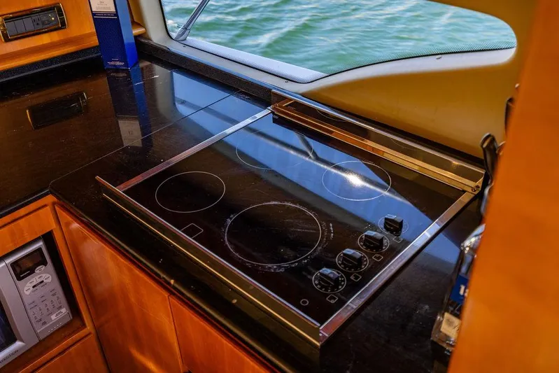 All In Yacht Photos Pics Modern kitchen on 2010 Azimut 62 Evolution Fly yacht with sleek black cooktop.