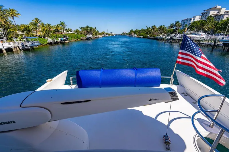 All In Yacht Photos Pics Azimut 62 Evolution Fly yacht on a scenic waterway with American flag, 2010 model.