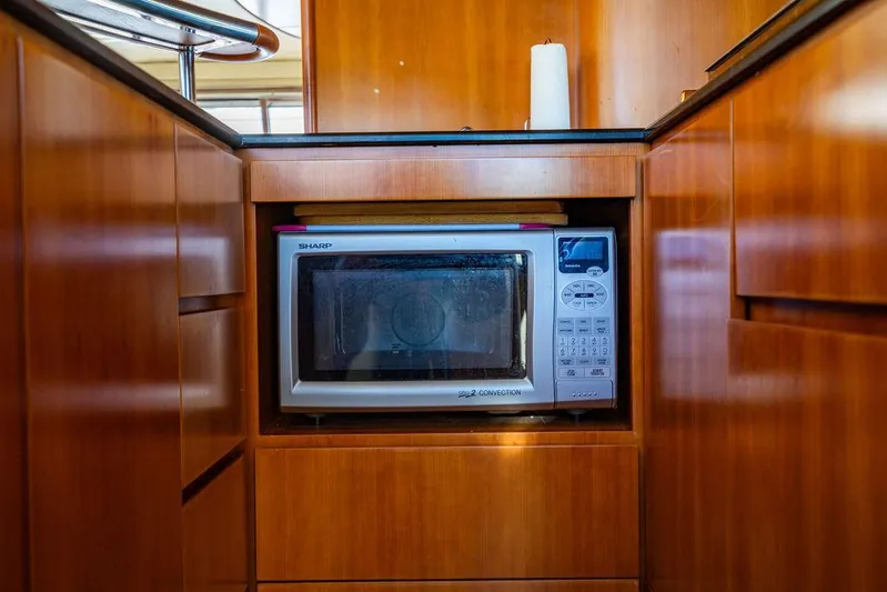 All In Yacht Photos Pics Microwave in wooden kitchen of 2010 Azimut 62 Evolution Fly yacht.