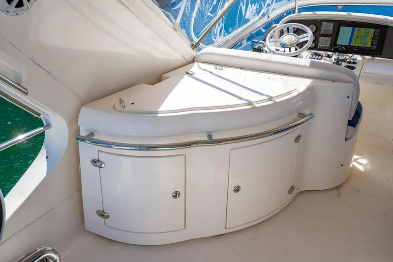 All In Yacht Photos Pics Flybridge helm station on 2010 Azimut 62 Evolution Fly yacht, featuring sleek design and modern controls.