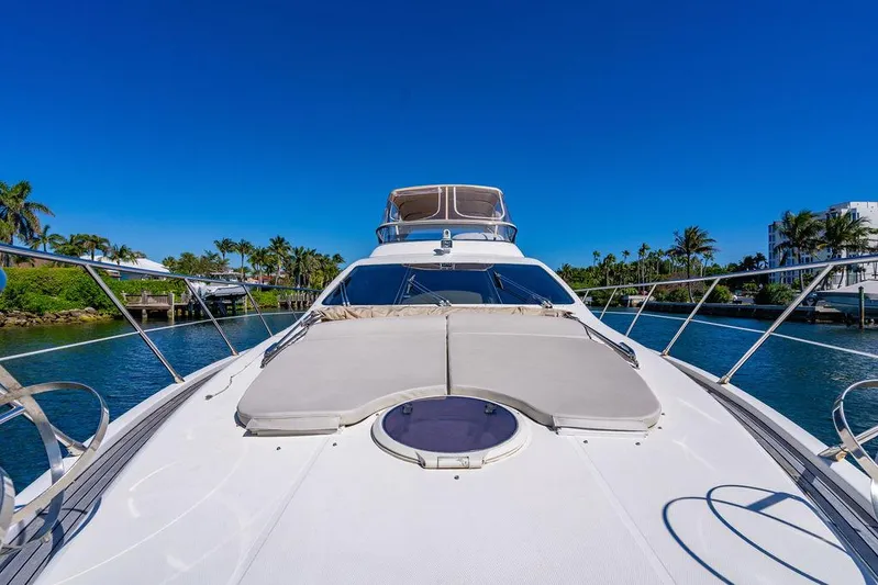 All In Yacht Photos Pics Azimut 62 Evolution Fly 2010 yacht on serene water, clear blue sky, and lush greenery.