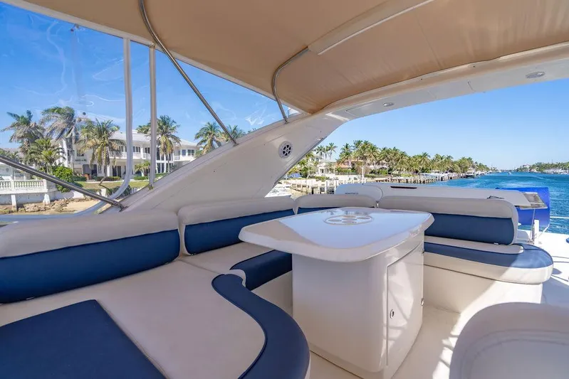All In Yacht Photos Pics Luxurious 2010 Azimut 62 Evolution Fly yacht with elegant seating and scenic waterfront view.