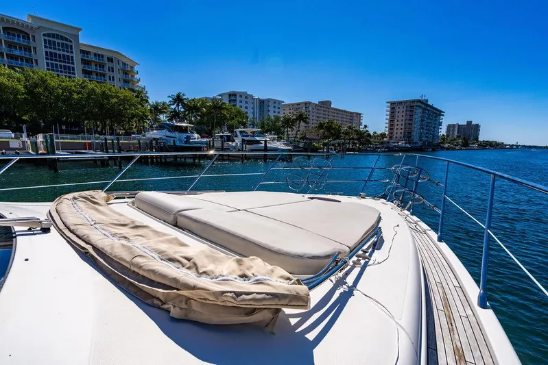 All In Yacht Photos Pics Azimut 62 Evolution Fly 2010 yacht docked in sunny marina with cityscape background.