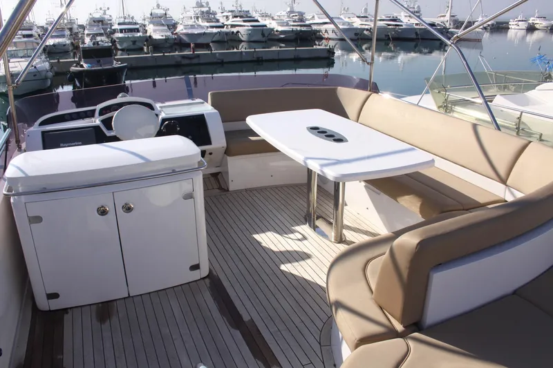  Yacht Photos Pics Luxurious 2011 Princess 54 yacht interior with seating and table, docked at marina.