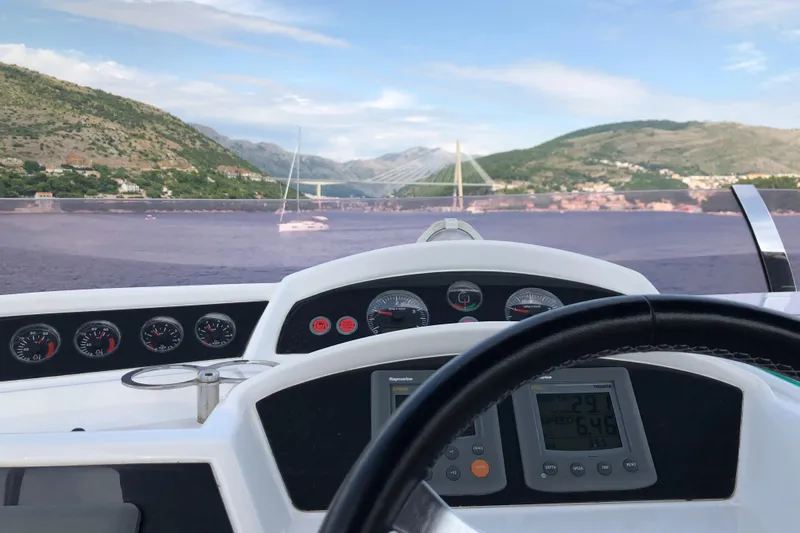  Yacht Photos Pics Cockpit view from a 2011 Princess 54 yacht, overlooking scenic coastal landscape.