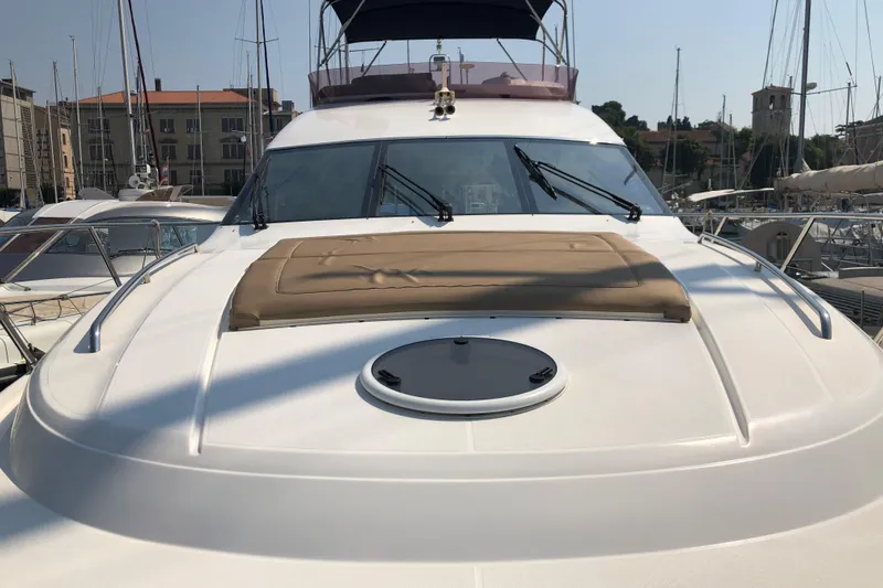  Yacht Photos Pics 2011 Princess 54 yacht docked in marina, featuring sunpad and sleek design.