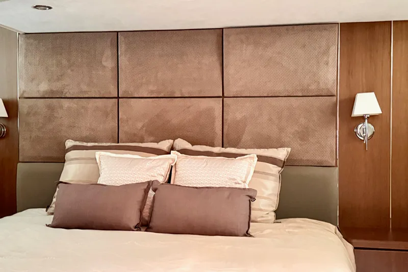  Yacht Photos Pics Luxurious bedroom interior on 2011 Princess 54 yacht with elegant bedding and wall sconces.