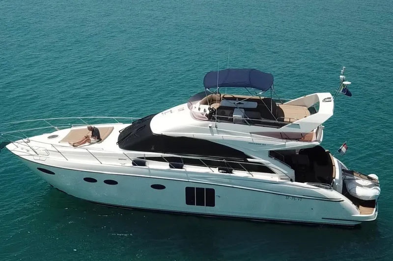  Yacht Photos Pics Luxurious 2011 Princess 54 yacht cruising on clear blue waters.