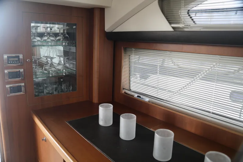  Yacht Photos Pics Luxurious interior of 2011 Princess 54 yacht with glass cabinet and window blinds.