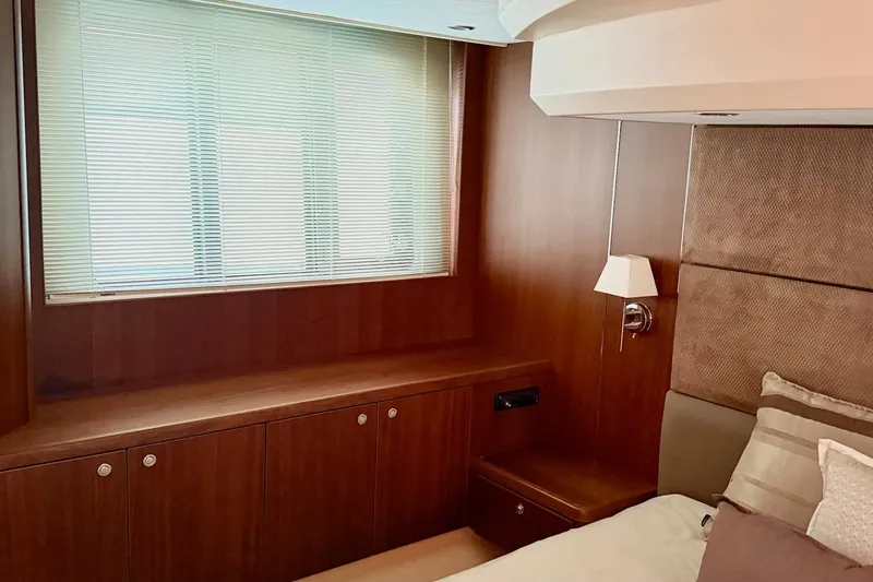  Yacht Photos Pics Luxurious cabin interior of 2011 Princess 54 yacht with wooden paneling and window blinds.