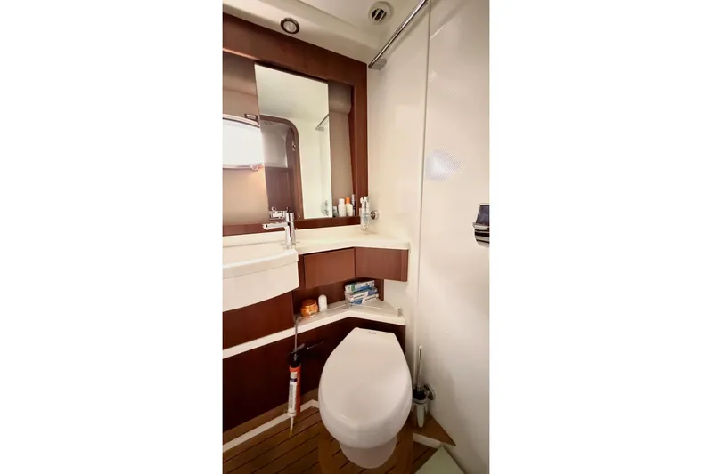  Yacht Photos Pics Luxurious bathroom in 2011 Princess 54 yacht with modern fixtures and wooden accents.