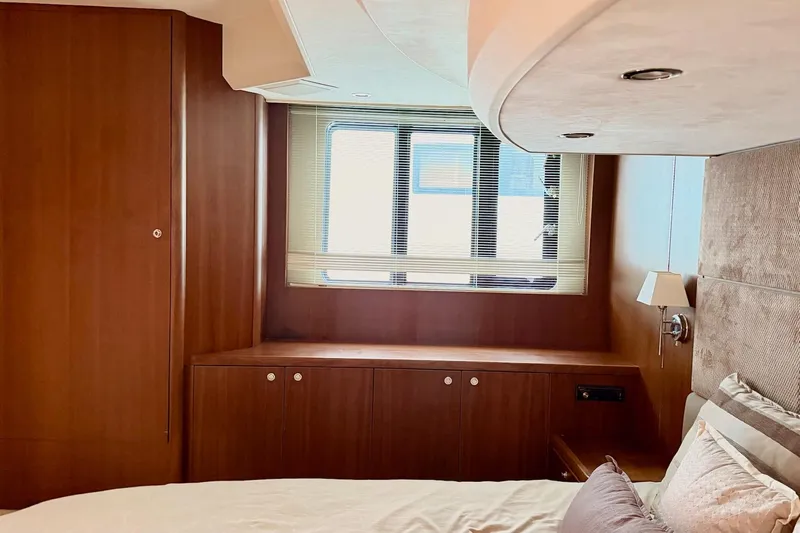  Yacht Photos Pics Luxurious cabin interior of 2011 Princess 54 yacht with wood paneling and window blinds.