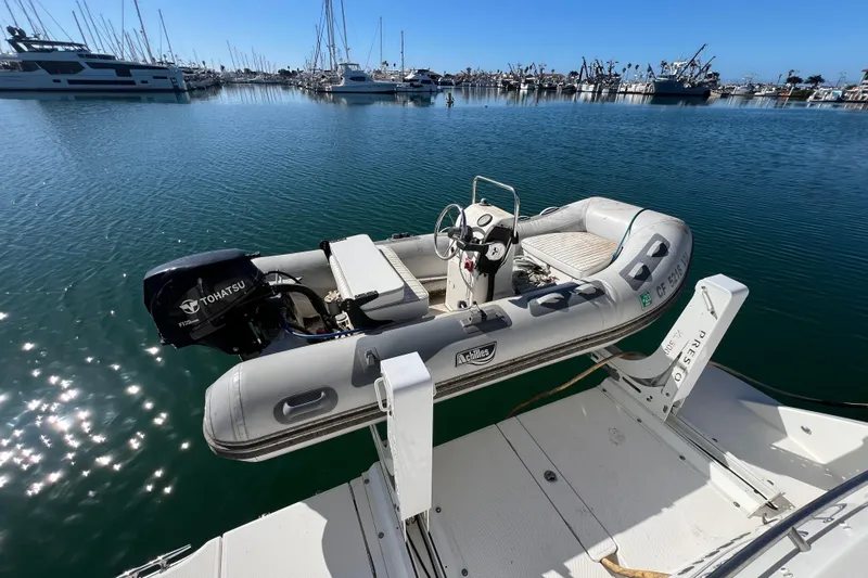  Yacht Photos Pics Inflatable boat with Tohatsu motor docked on a 2013 Meridian 441 Sedan yacht.