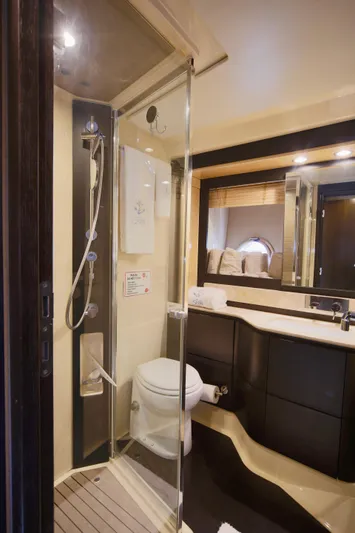 Kiki Yacht Photos Pics Luxurious bathroom in 2016 Azimut 66 yacht with modern shower and sleek fixtures.