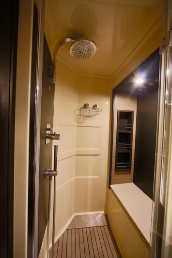 Kiki Yacht Photos Pics Luxurious shower in 2016 Azimut 66 yacht with modern fixtures and wooden flooring.