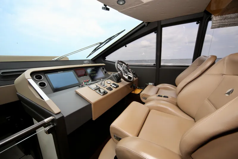 Kiki Yacht Photos Pics 2016 Azimut 66 yacht cockpit with leather seats and modern control panel.