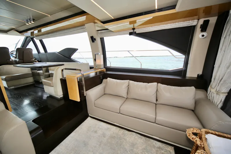 Kiki Yacht Photos Pics Luxurious interior of a 2016 Azimut 66 yacht with elegant seating and panoramic windows.