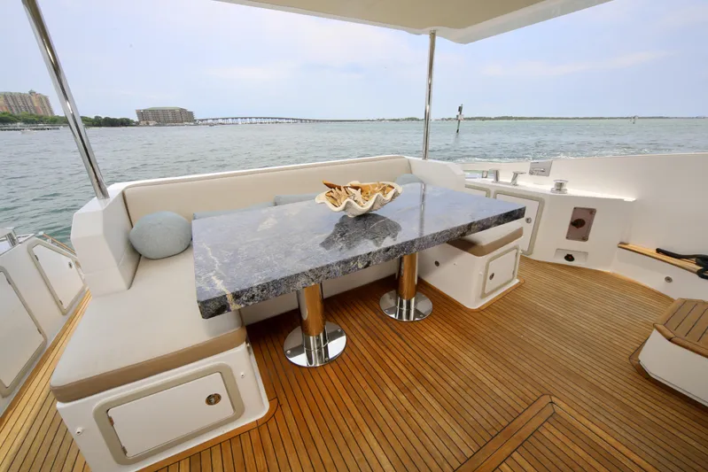 Kiki Yacht Photos Pics Luxurious 2016 Azimut 66 yacht deck with elegant seating and marble table.