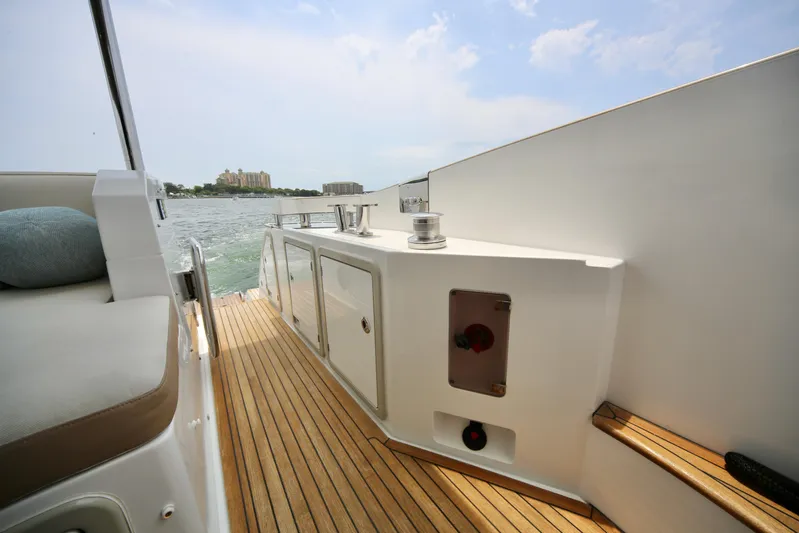 Kiki Yacht Photos Pics Luxurious 2016 Azimut 66 yacht deck with teak flooring and ocean view.