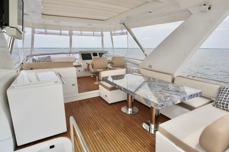 Kiki Yacht Photos Pics Luxurious interior of 2016 Azimut 66 yacht with elegant seating and ocean view.