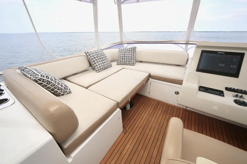 Kiki Yacht Photos Pics Luxurious seating area on 2016 Azimut 66 yacht with ocean view and modern controls.