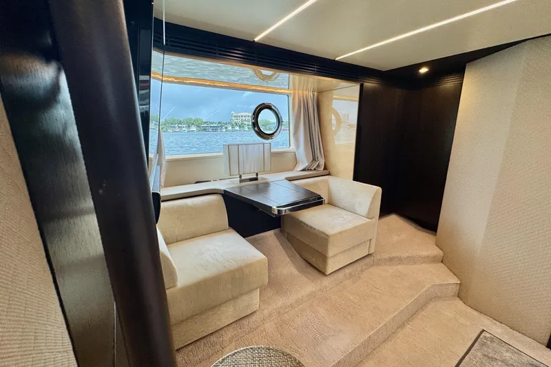 Kiki Yacht Photos Pics Luxurious interior of 2016 Azimut 66 yacht with elegant seating and scenic window view.