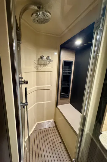 Kiki Yacht Photos Pics Luxurious shower in 2016 Azimut 66 yacht with modern fixtures and wooden flooring.