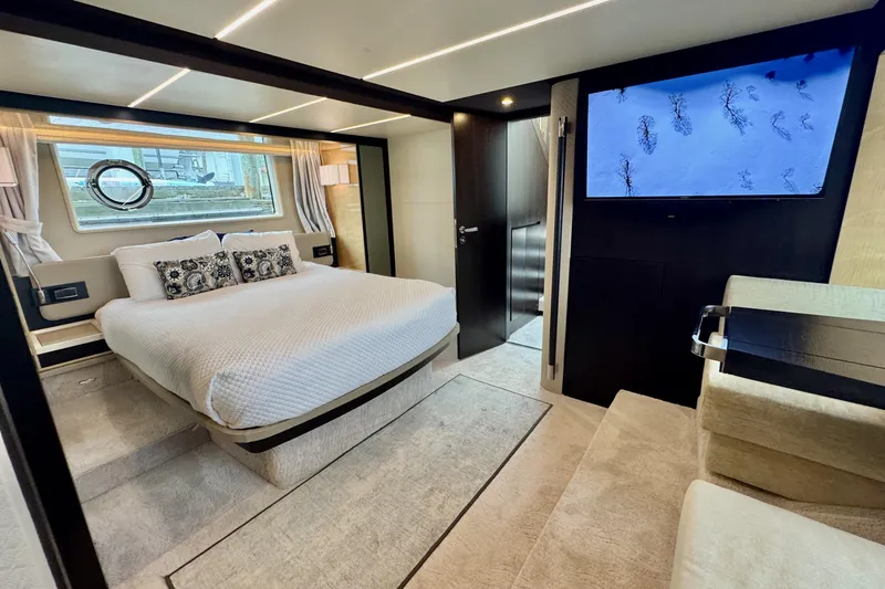 Kiki Yacht Photos Pics Luxurious bedroom interior of a 2016 Azimut 66 yacht with modern decor and a large bed.