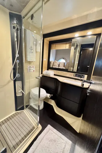 Kiki Yacht Photos Pics Luxurious bathroom in 2016 Azimut 66 yacht with modern fixtures and glass shower.