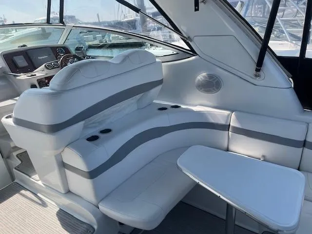  Yacht Photos Pics 2005 Formula 34PC boat interior with white seating and table, featuring modern design elements.