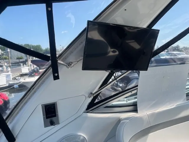  Yacht Photos Pics Interior of 2005 Formula 34PC boat with mounted TV and seating area.