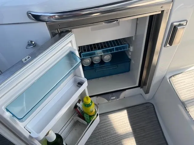  Yacht Photos Pics Small refrigerator on a 2005 Formula 34PC boat, stocked with drinks and condiments.